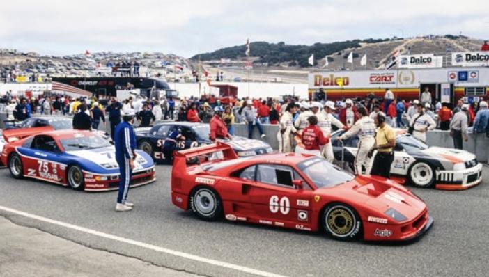 Red Ferrari F40 Competizione number 60 in the IMSA race paddock with other race cars