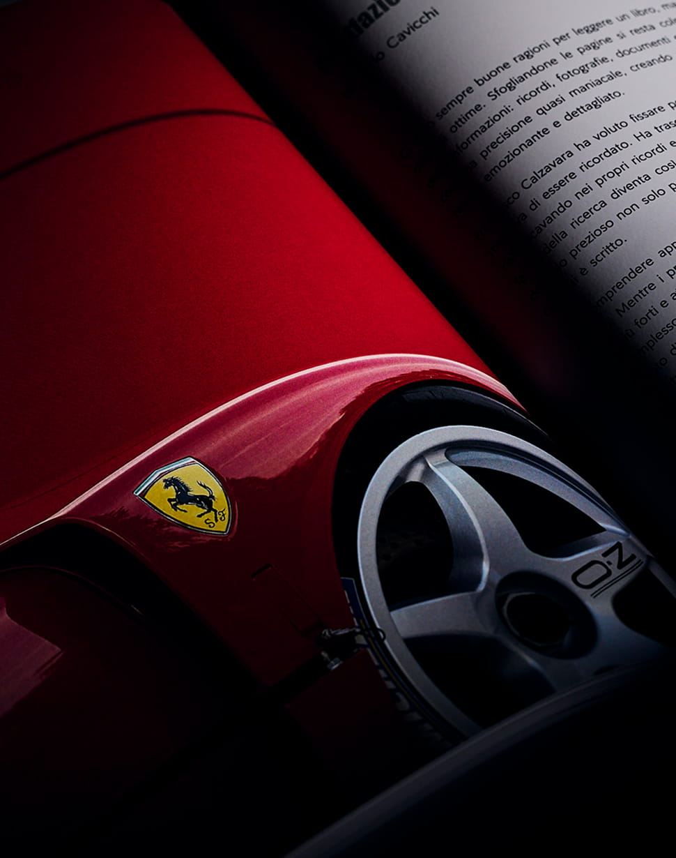 Book page showing the Ferrari Cavallino Rampante badge on the red F40 bodywork